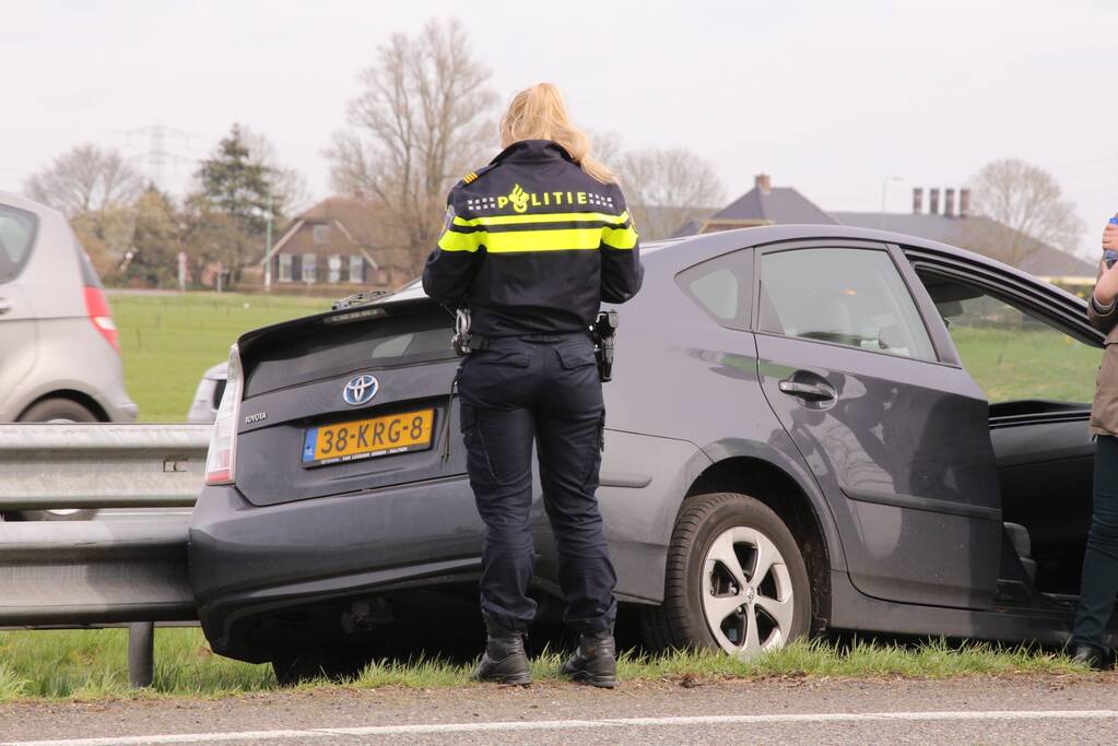 Auto duikt vangrail in