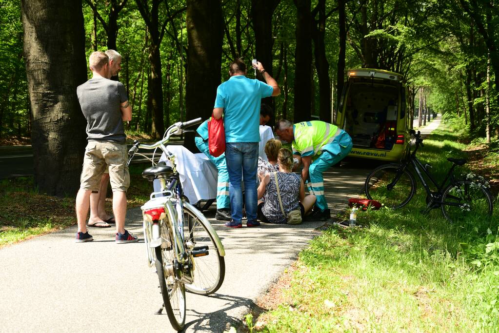 Omstanders verlenen eerste hulp aan gewonde fietsster