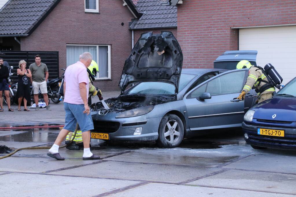 Auto vat vlam voor de garage