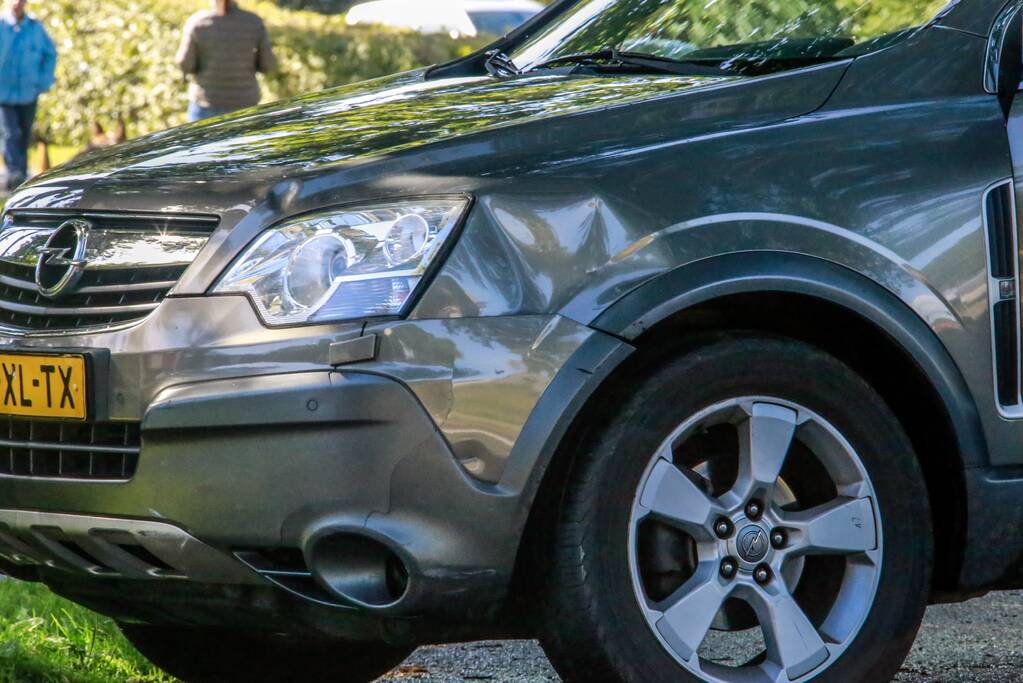 Overstekende scootmobiel aangereden