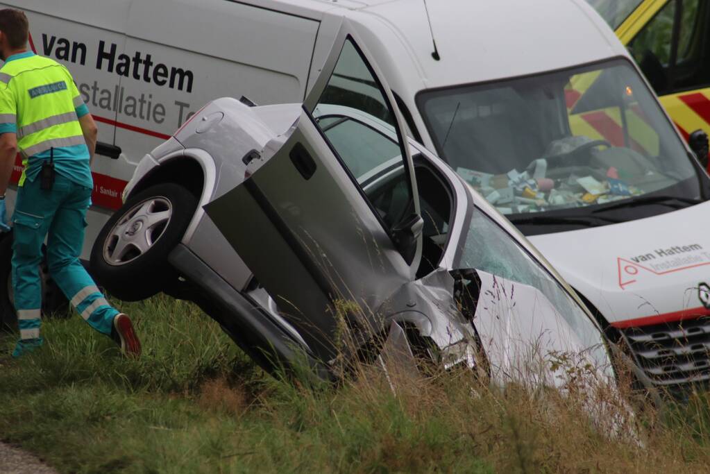 Bestelbus en auto belandt in greppel na botsing