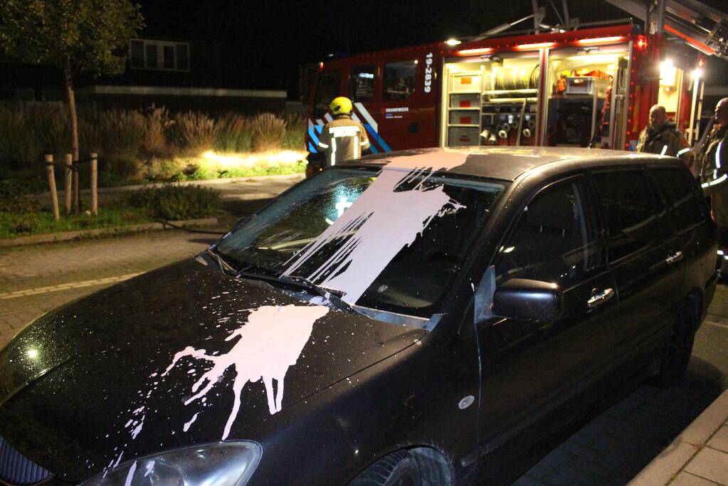 Auto met vloeistof besmeurd, schutting in brand gestoken