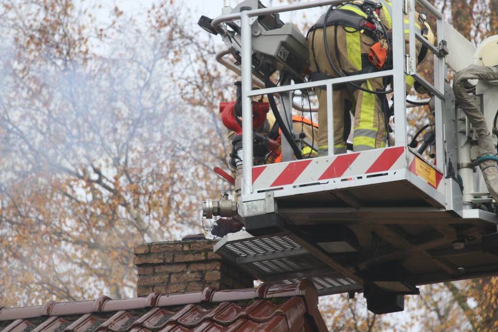 Brandweer veegt schoorsteen na brand