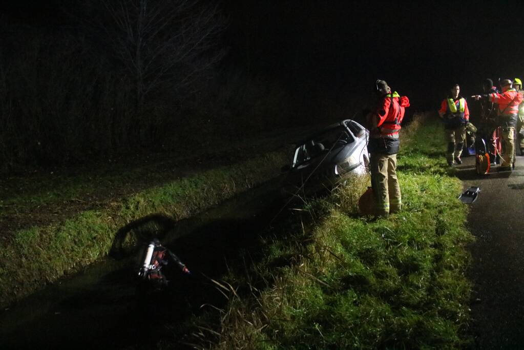 Auto raakt van dijk, brandweer doorzoekt sloot