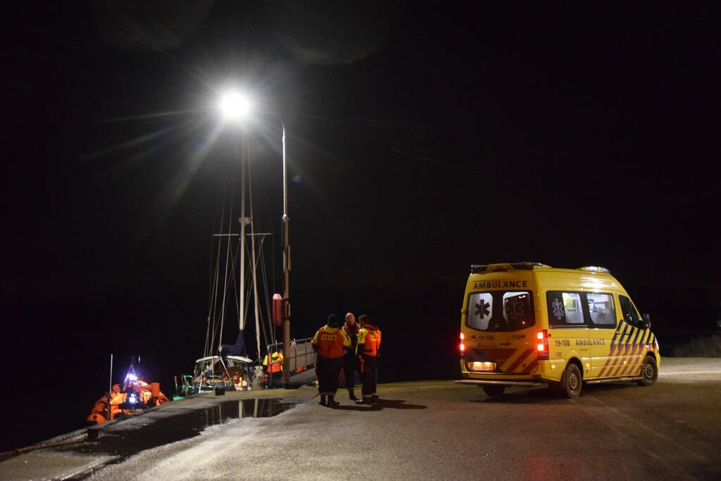 Man valt van zeilboot en belt met smartwatch hulpdiensten