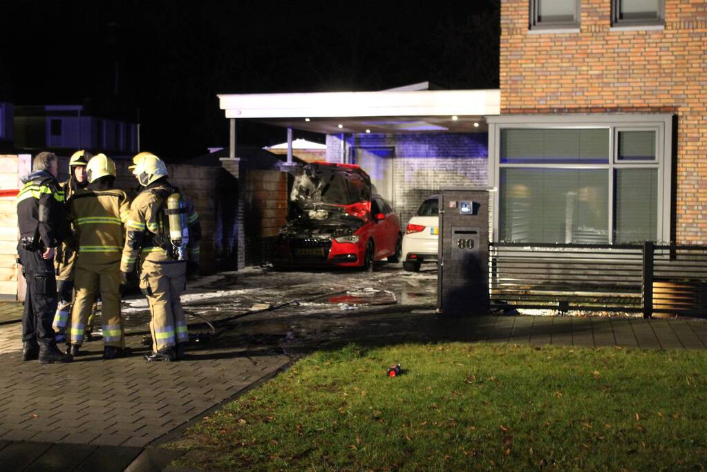 Auto in de brand onder carport