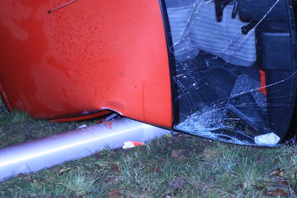 Auto op zijn kant, bestuurder gewond