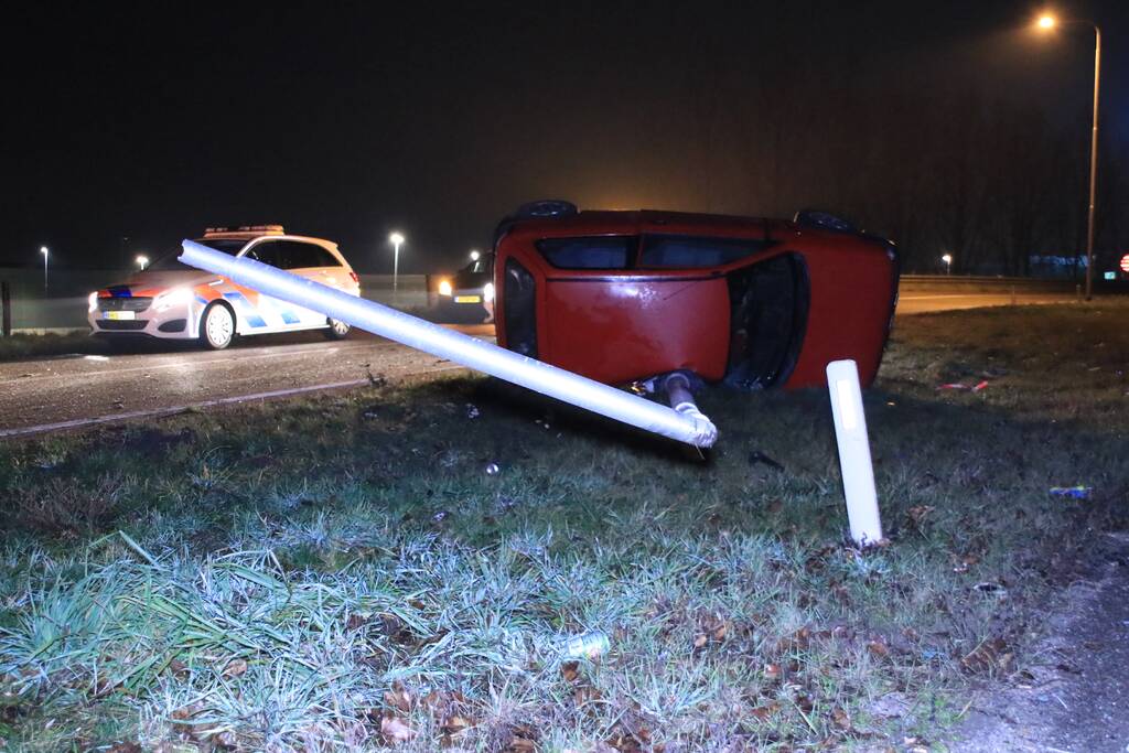 Auto op zijn kant, bestuurder gewond