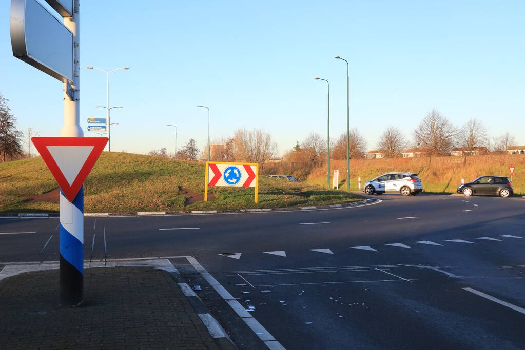 Twee personenauto's botsen op elkaar op rotonde