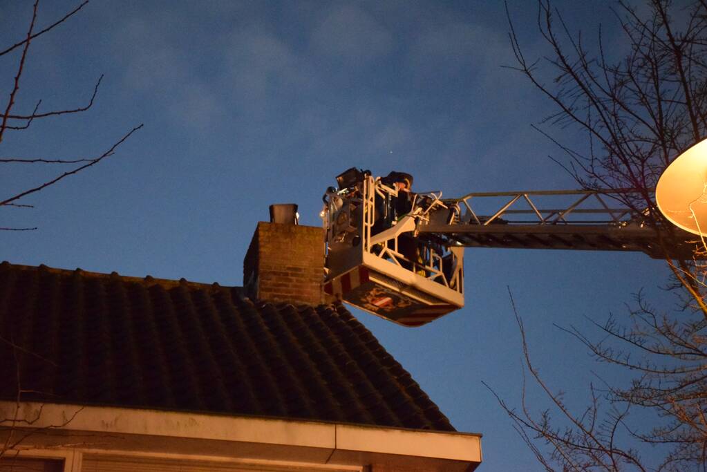 Brandweer controleert schoorsteenbrand met hoogwerker