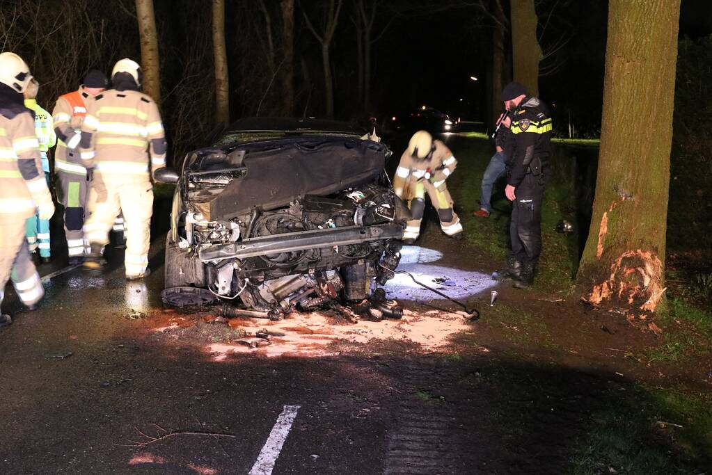 Bestuurder bekneld na botsing op boom