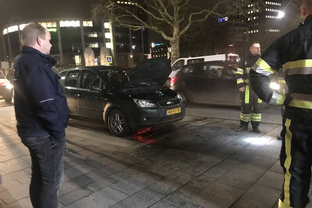 Brandweer inspecteert auto na brand