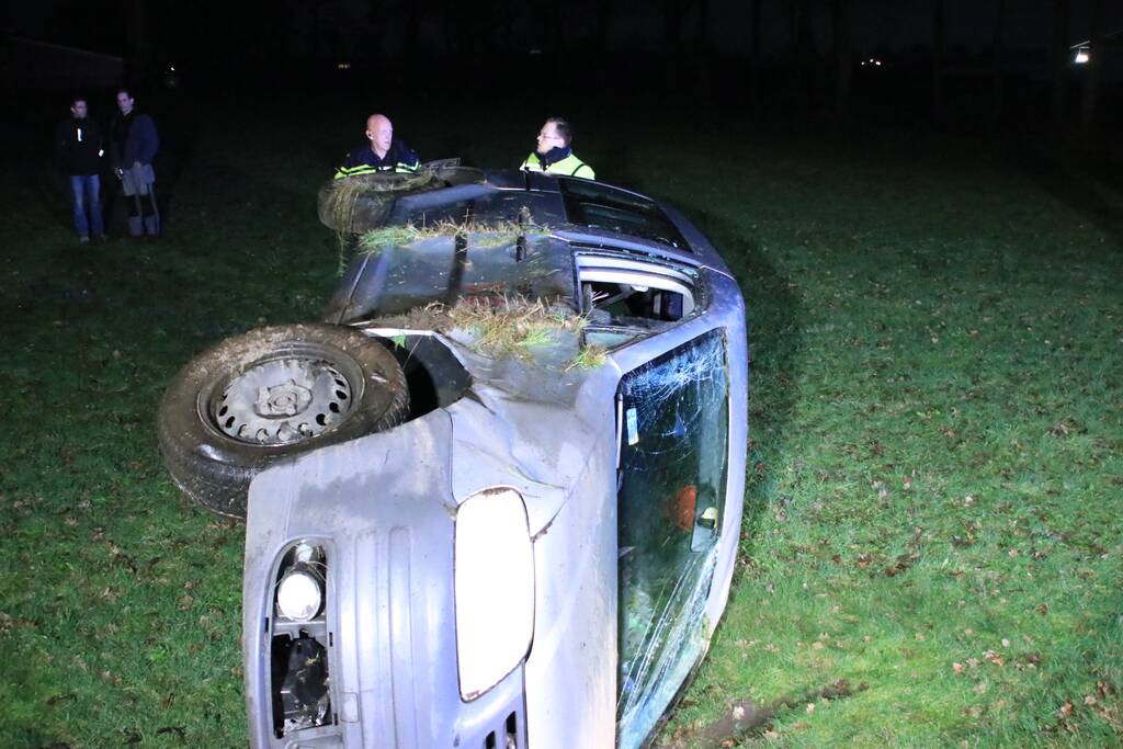 Bestelbus vliegt uit de bocht en belandt op zijkant, twee aanhoudingen