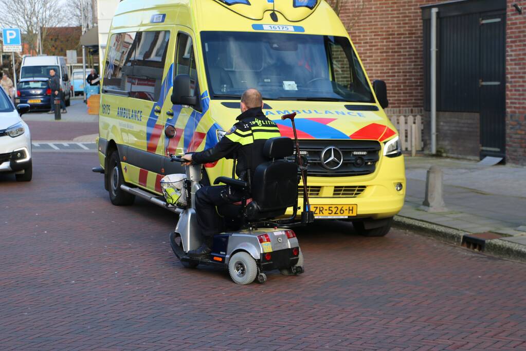 Persoon in scootmobiel ten val