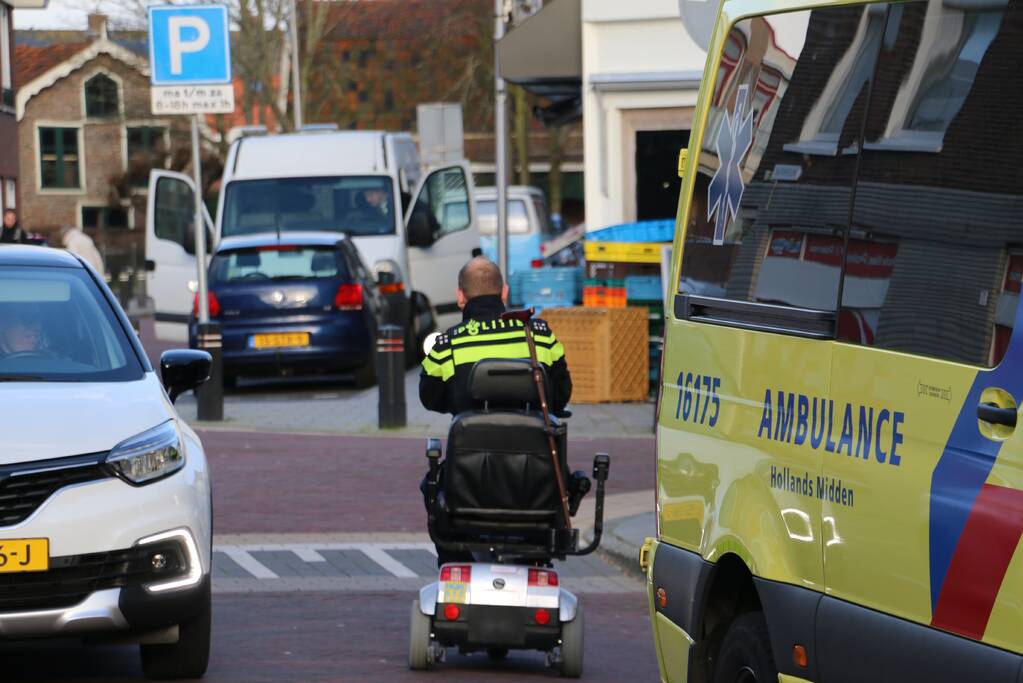 Persoon in scootmobiel ten val