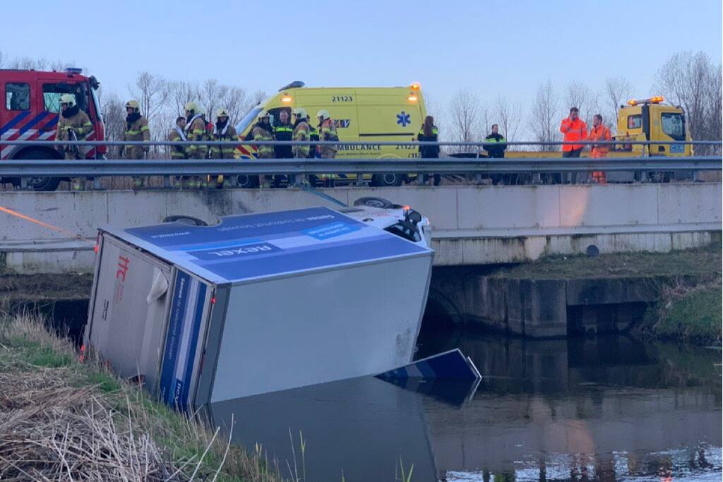 Bestelbus raakt van de weg en belandt te water