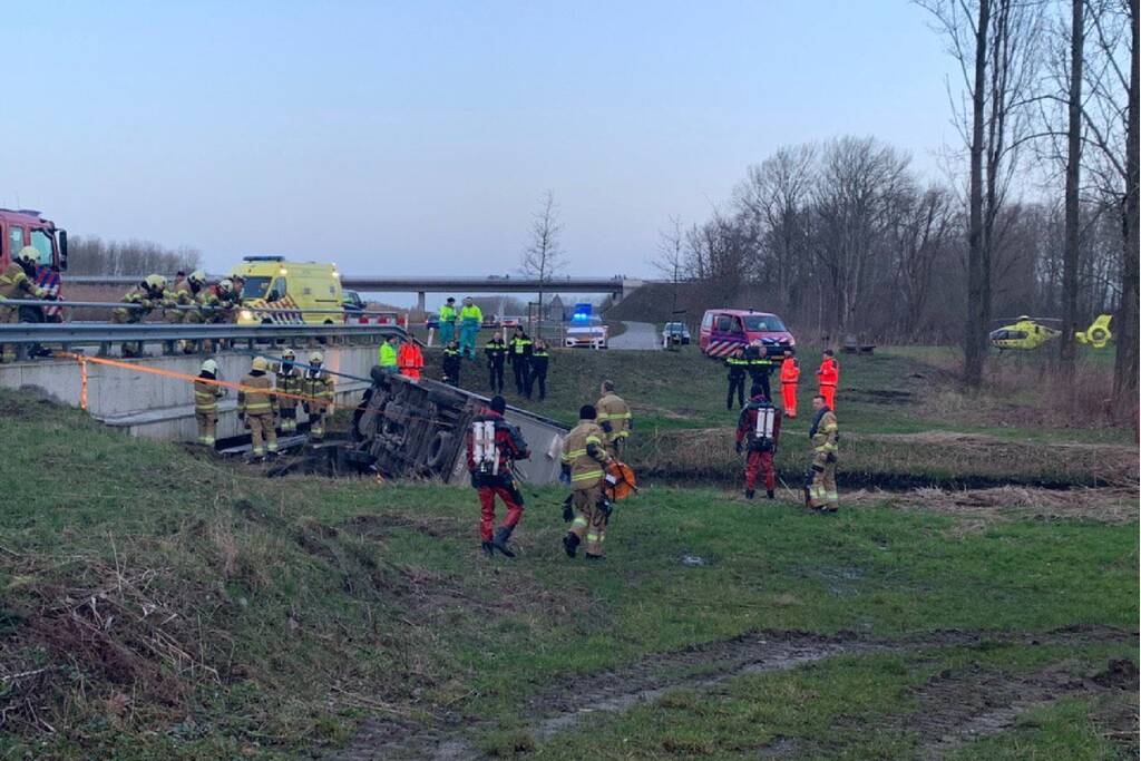 Bestelbus raakt van de weg en belandt te water