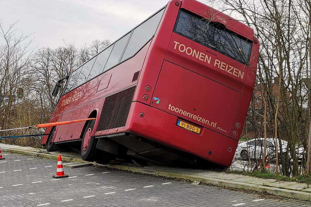 Touringcar rijdt talud af