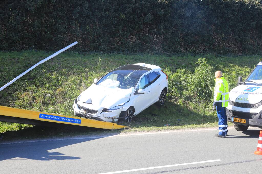 Auto vliegt uit de bocht en belandt op geluidswal