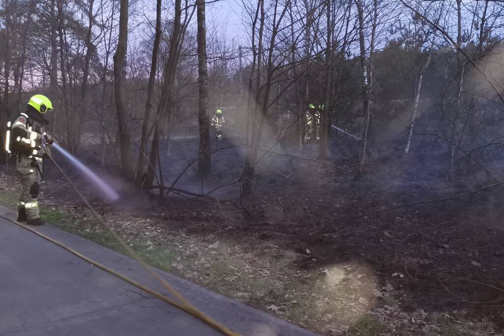 Groot stuk bosschage langs spoor in brand
