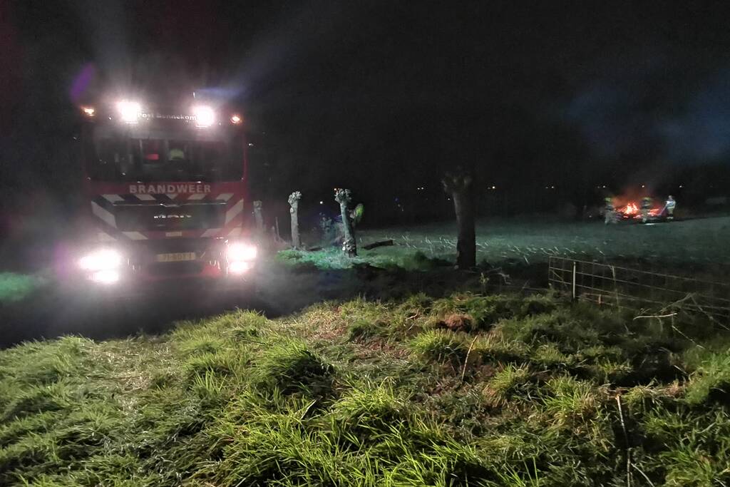 Berg met takken in weiland vatte vlam