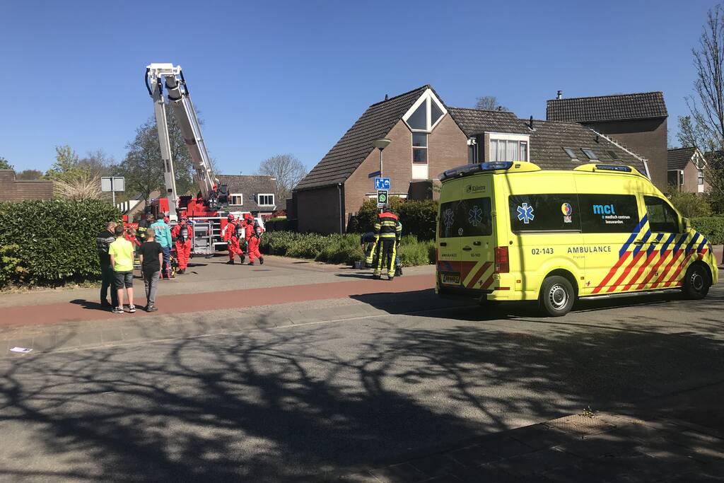 Brandweer in beschermende pakken halen persoon uit woning