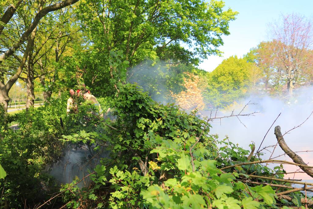Struiken in brand op geluidswal
