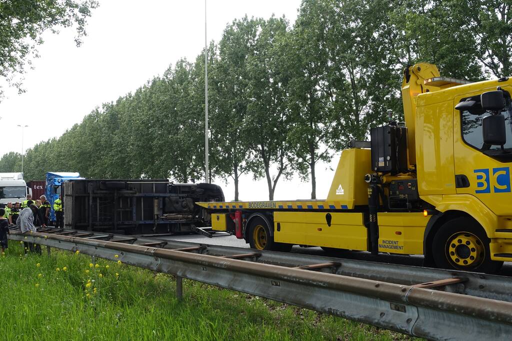 Bestelbus belandt op zijn kant, vrachtwagen ramt vangrail