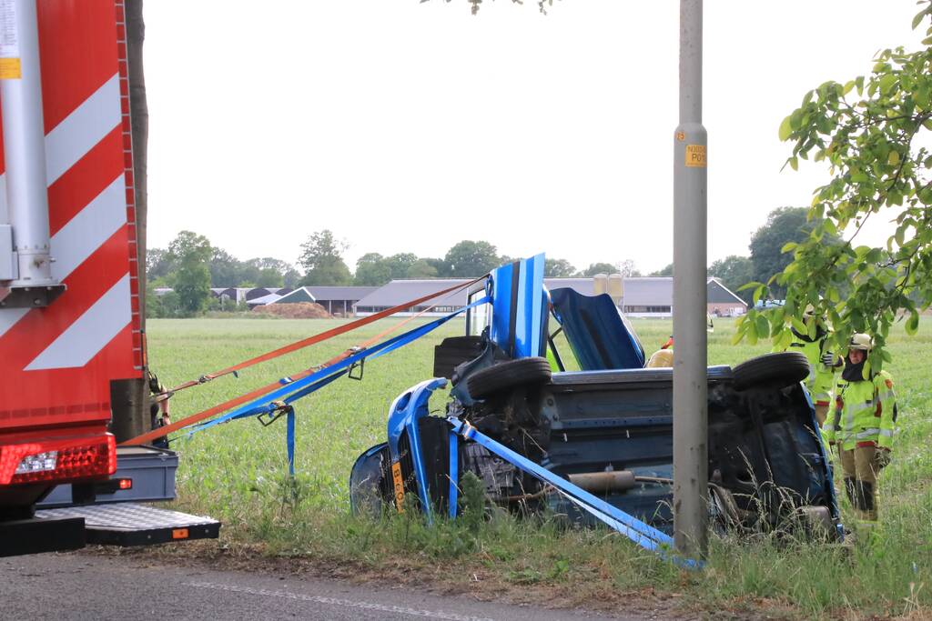 Auto belandt op zijn kant in weiland
