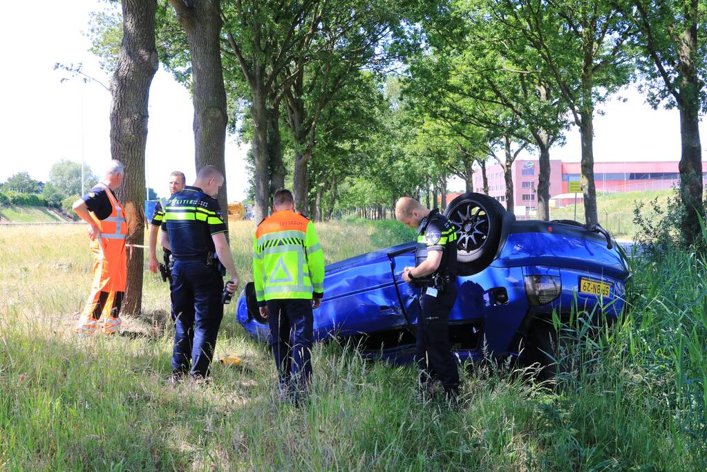 Auto raakt van snelweg en belandt op de kop