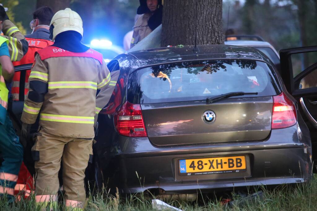 Bestuurder bekneld bij botsing tegen boom