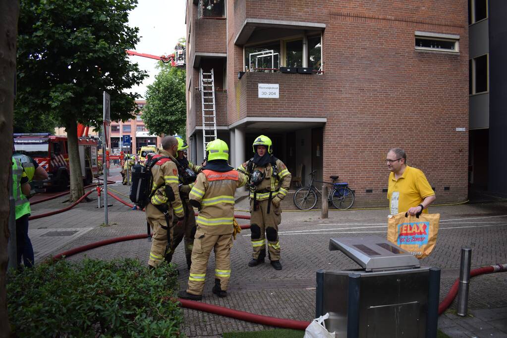 Brand in appartement, bewoners gered met hoogwerker