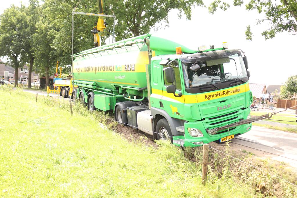 Vrachtwagen met bulkoplegger zakt weg in berm