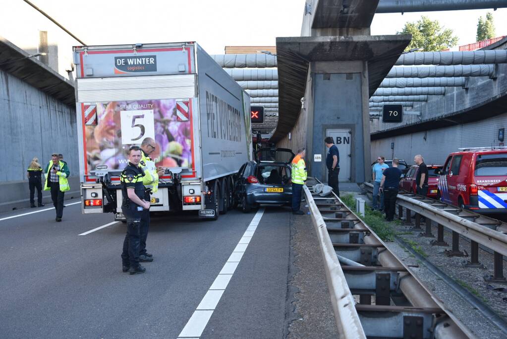 Auto klem tussen vangrail en vrachtwagen in Beneluxtunnel