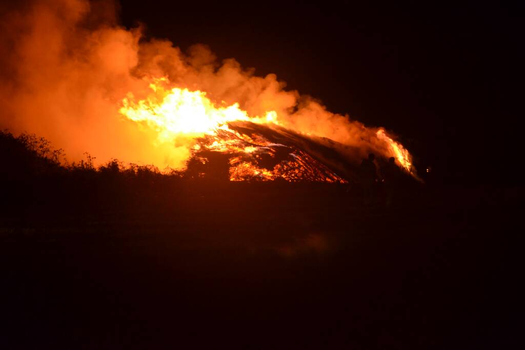 Grote stapel met wilgenhout vliegt in brand