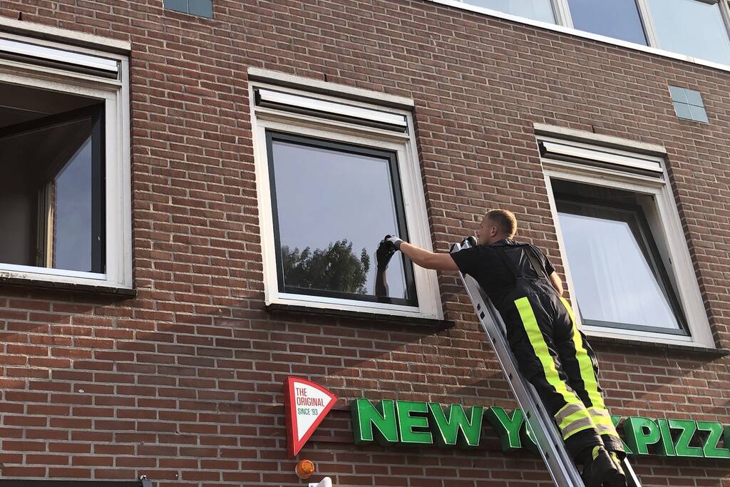 Kat vast tussen klapraam