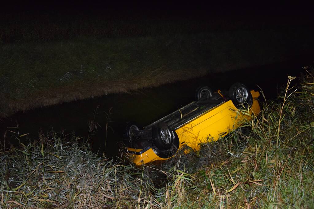 Auto belandt op de kop in het water