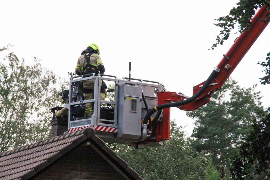 Brandweer veegt schoorsteen na brand
