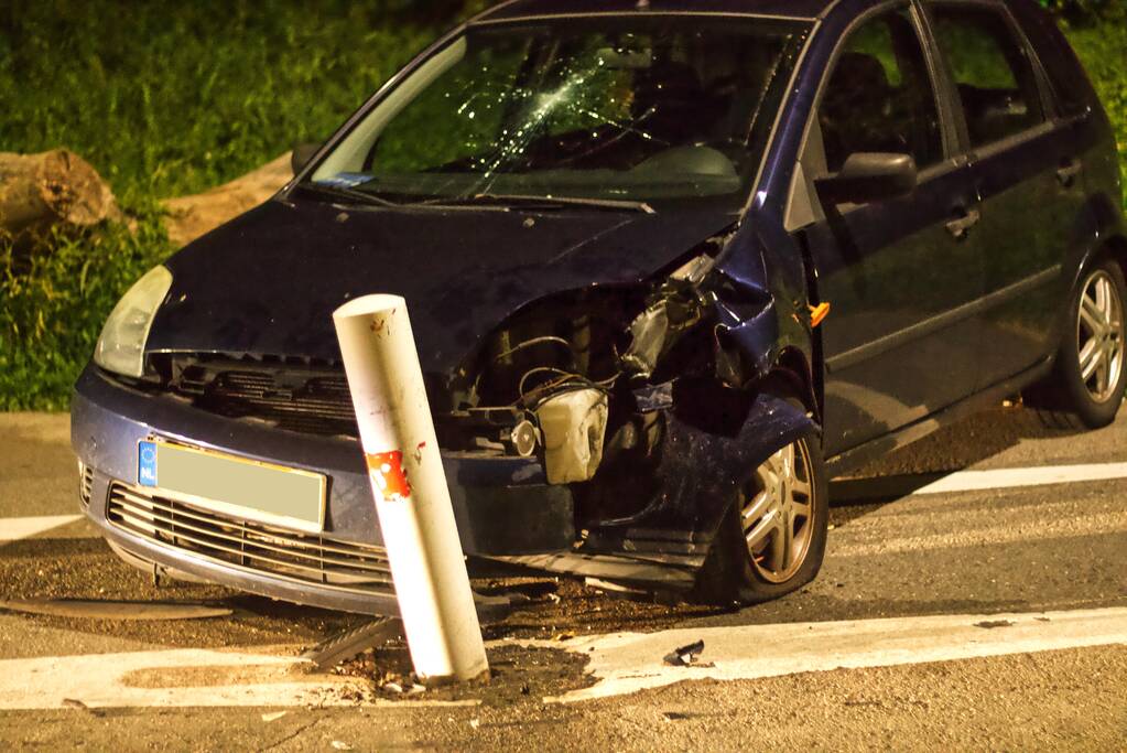 Auto rijdt tegen paal en voetganger