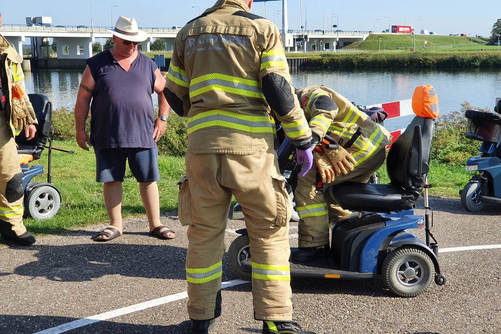 Vrouw rijdt met scootmobiel op verkeerspaal