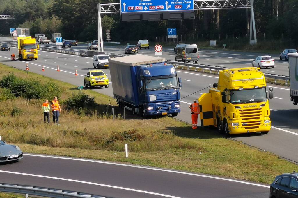 Vrachtwagen vast in de berm