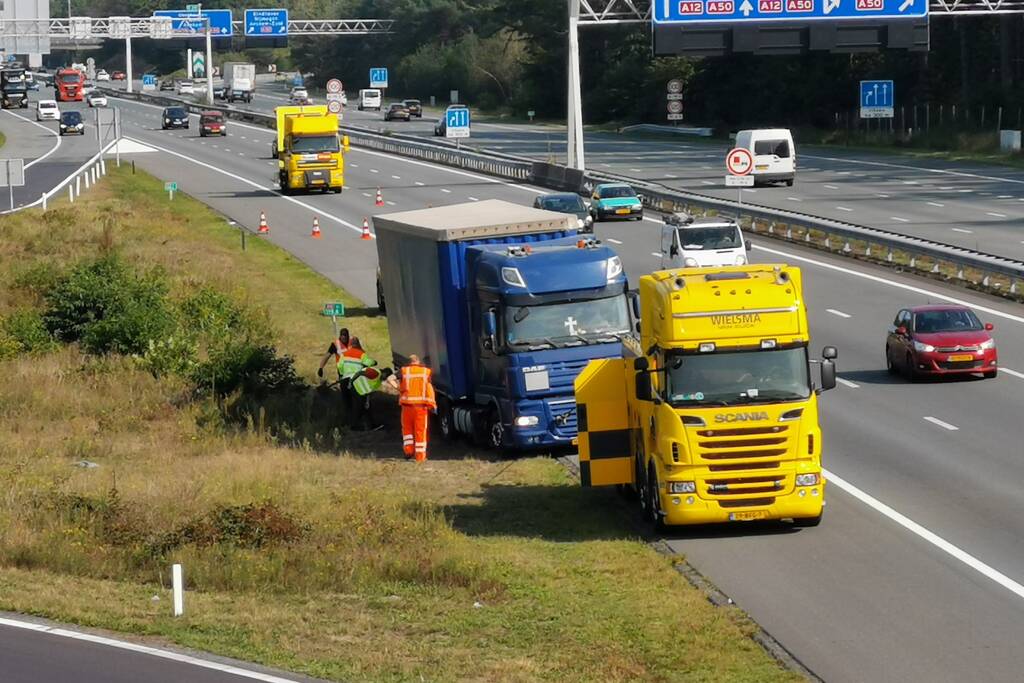 Vrachtwagen vast in de berm