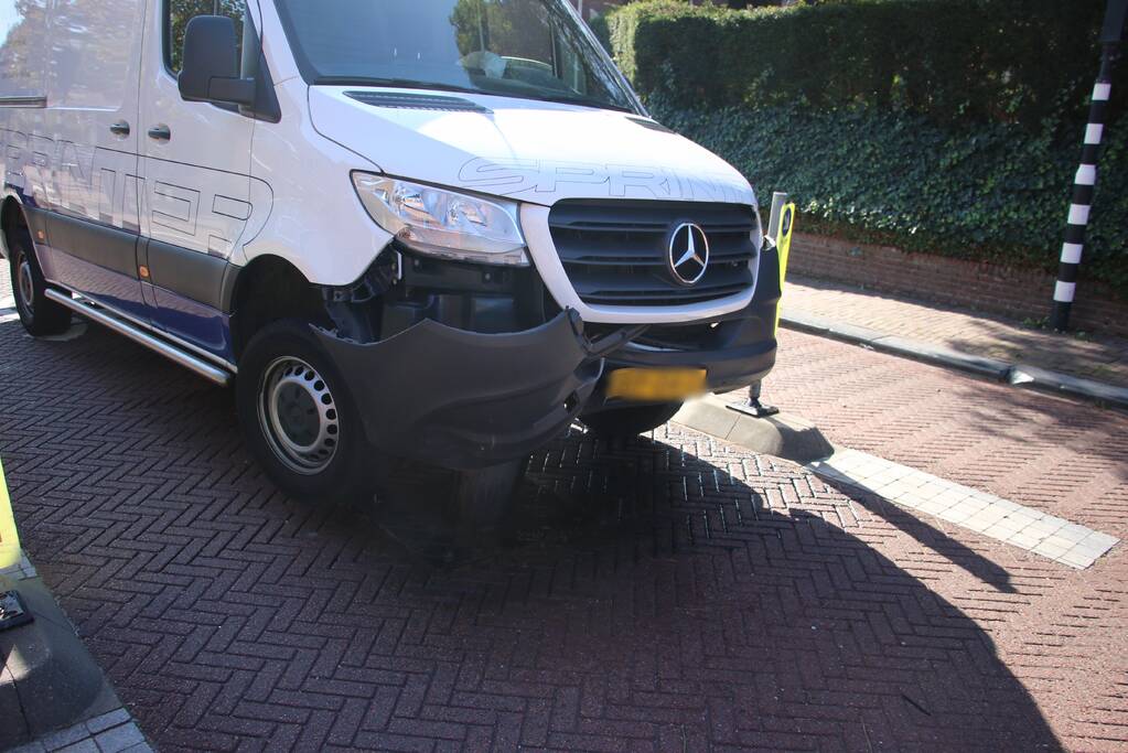 Bestelbus komt vast te zitten op paal van bussluis