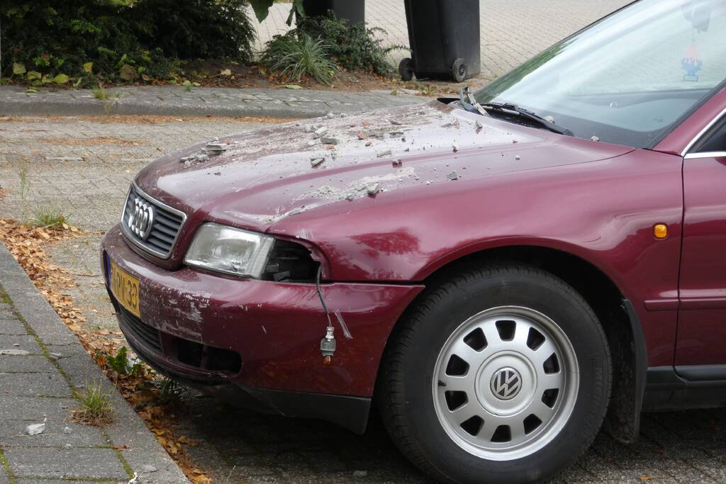 Automobilist rijdt garage in bij wegrijden