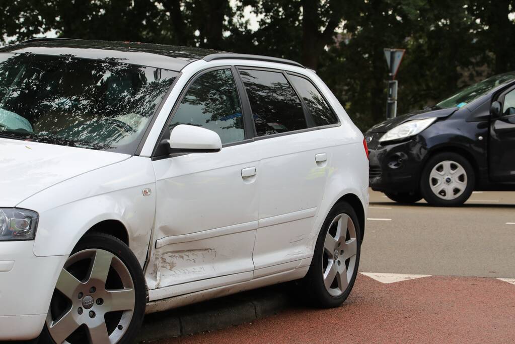 Schade bij aanrijding tussen twee auto's op kruising
