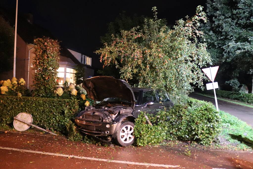 Auto rijdt heg in na botsing