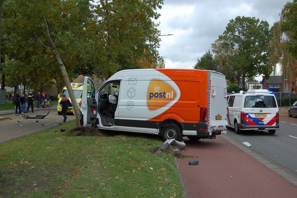 Bestelbus Postnl belandt met hoge snelheid tegen boom