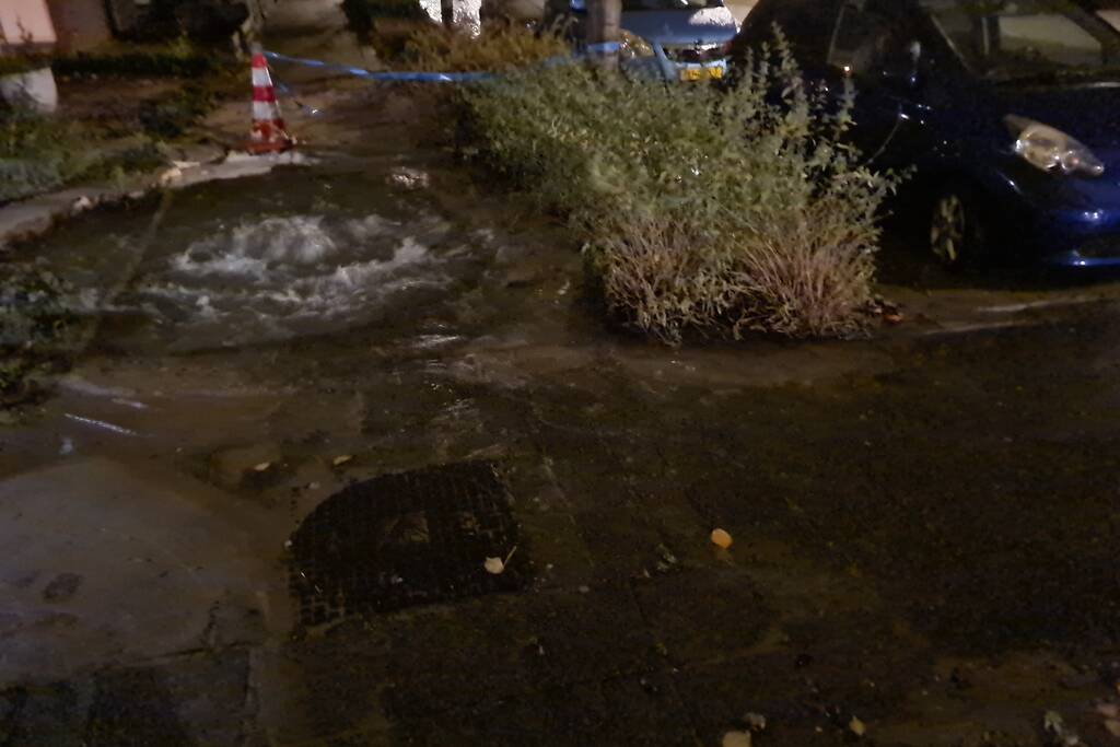 Straat onderwater door gesprongen hoofdwaterleiding