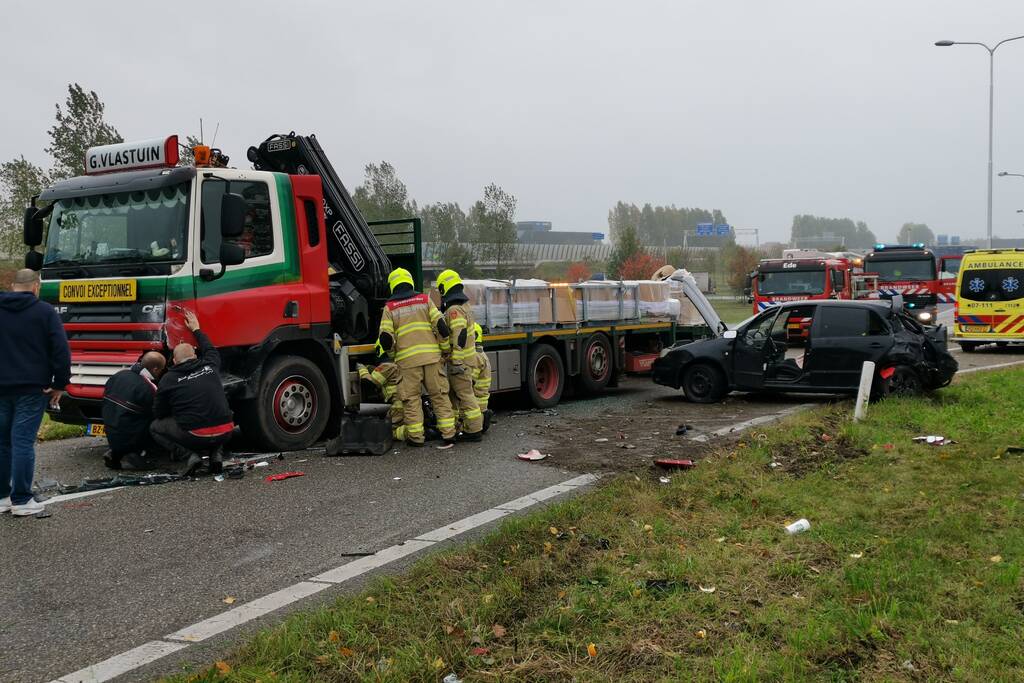 Auto van afrit geschoten, botst frontaal op vrachtwagen