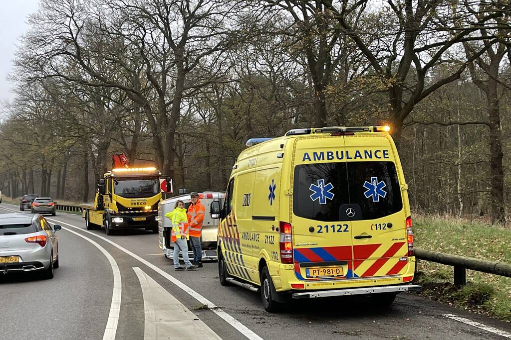 Bestelbus belandt op zijn kant via vangrail